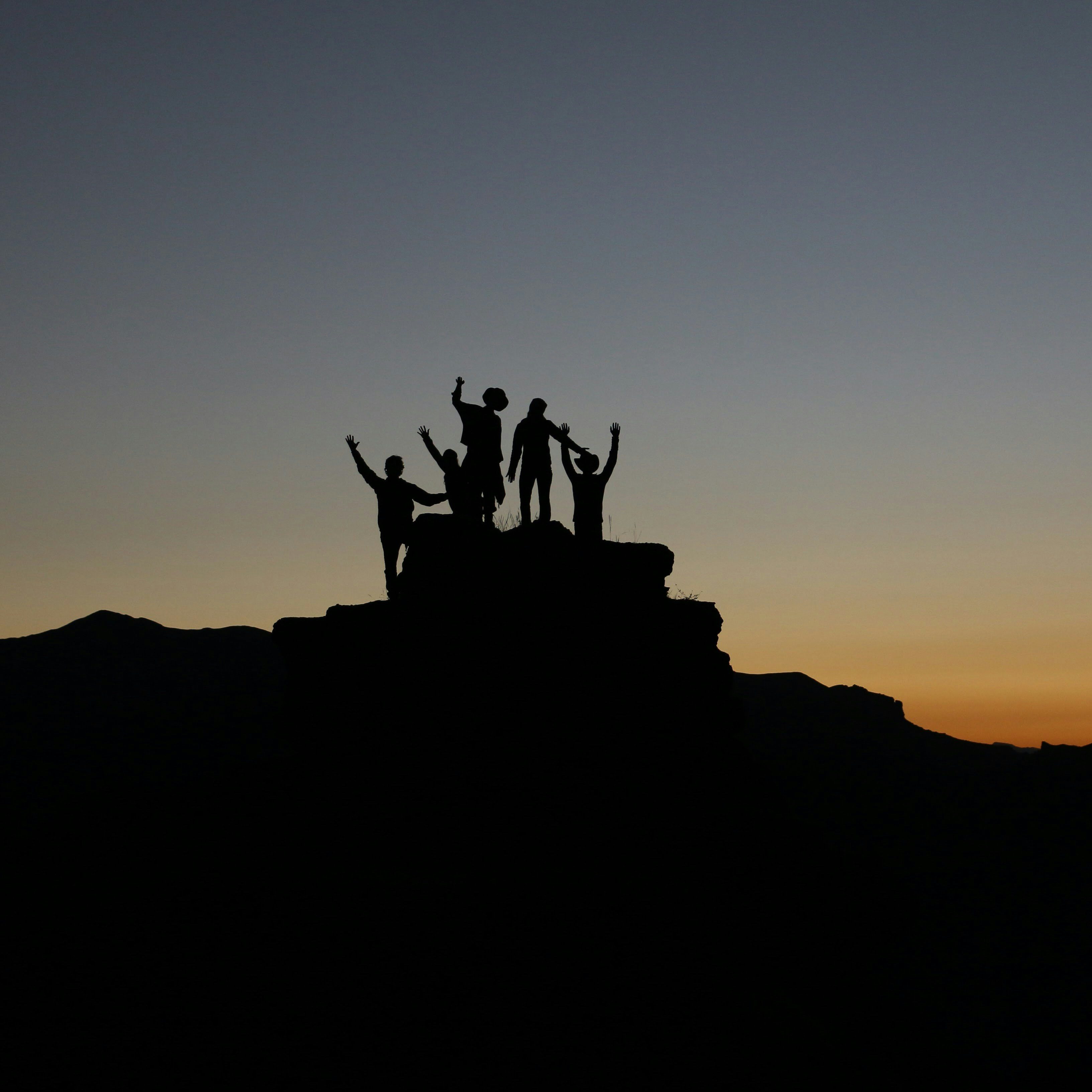 Photo of a team at the top of a hill celebrating
